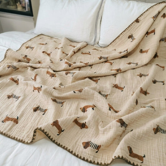 Cloud cotton muslin blanket in Frankie draped on bed — striped dachshund print, MonBebe Singapore