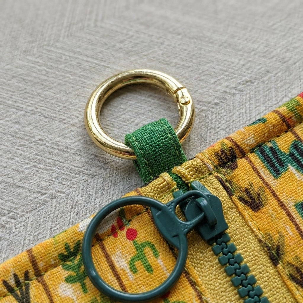 Close-up of gold D-ring clip on Little Farmhand Everyday Pouch, MonBebe Singapore