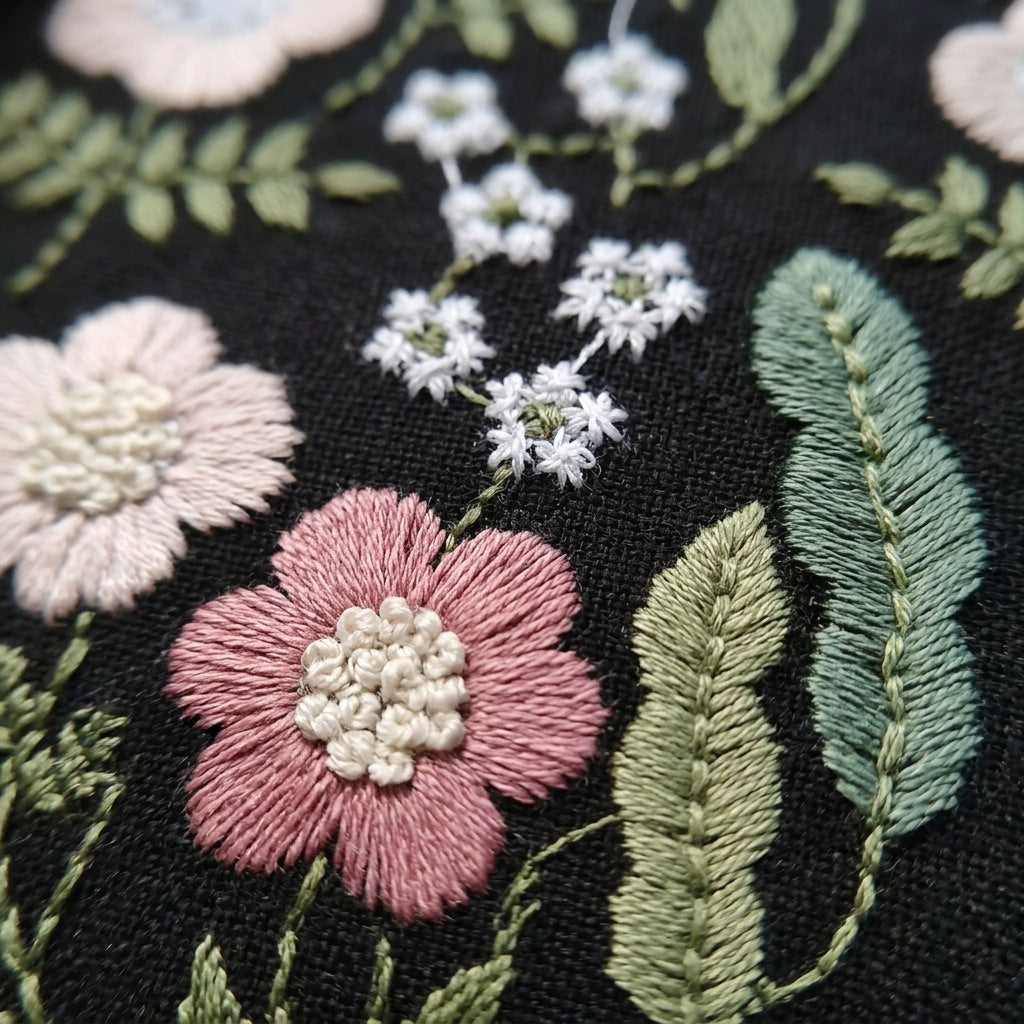 Close-up of hand embroidery detail on Briar pouch, MonBebe Singapore