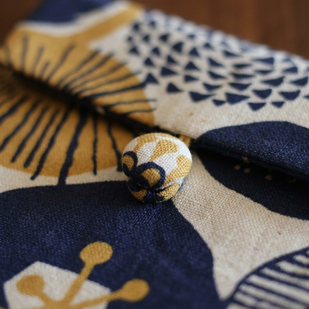 Close-up of fabric loop and button closure on Marin sleeve, MonBebe Singapore