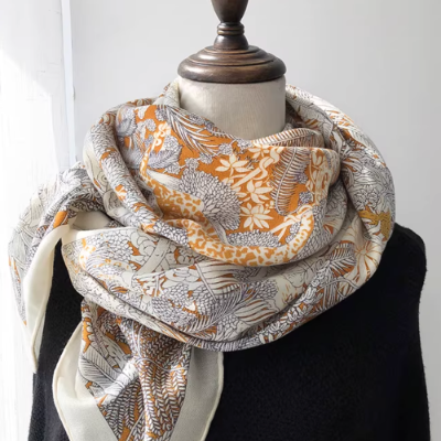 Silk-wool blend blanket scarf with botanical pattern in warm neutral tones, 135 × 135 cm