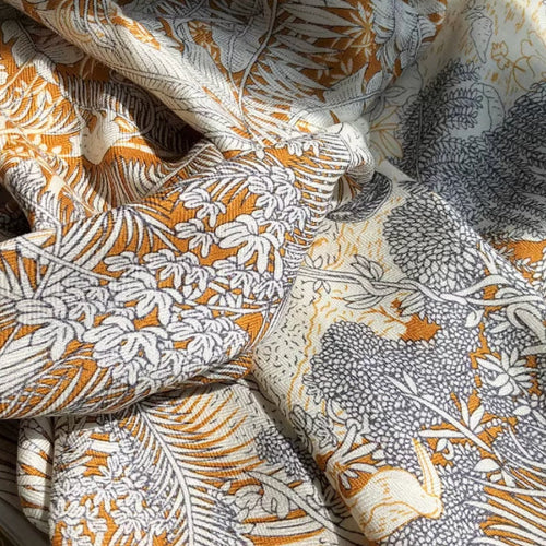 Close-up of silk-wool fabric showing soft texture and botanical pattern