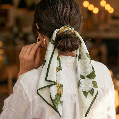 mulberry silk scarf with ivory floral gold chain print, worn on woman as hair tie