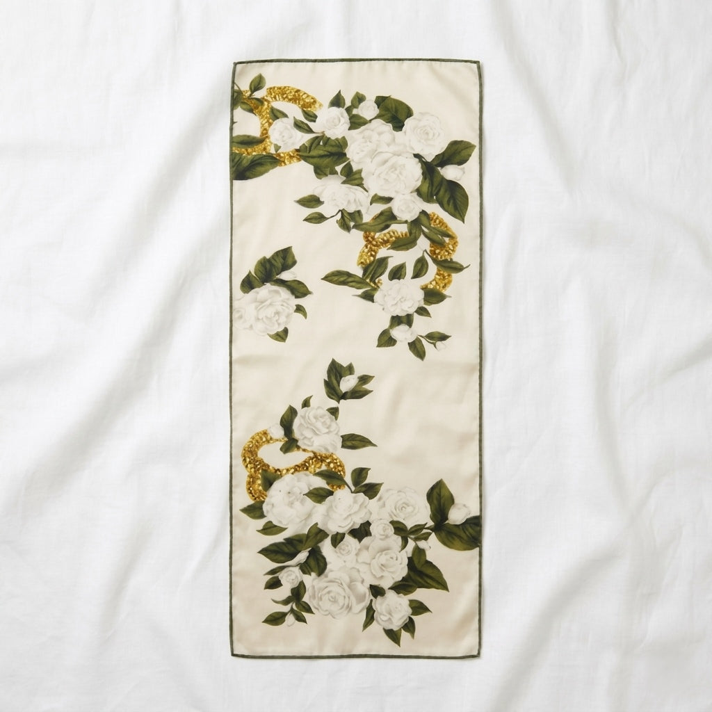 Camellia mulberry silk scarf, ivory with white camellia blooms, green leaves and gold chain detail laid flat showing full design —  MonBebe Singapore