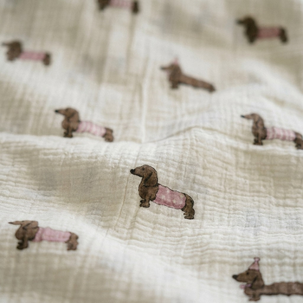Close-up of dressed dachshund print on Cloud cotton muslin blanket Pudding — MonBebe Singapore
