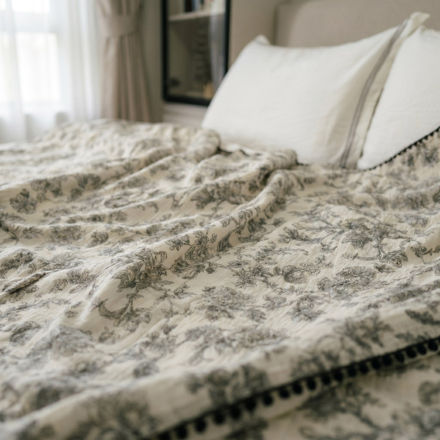 Cloud cotton muslin blanket in Secret Garden draped on bed black botanical print —  MonBebe Singapore