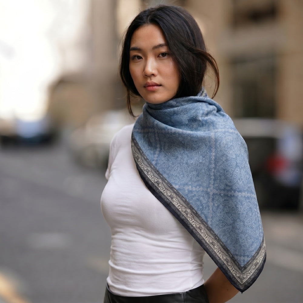 Woman wearing Demi reversible silk-wool square scarf draped as a shawl over her shoulders, lifestyle shot, MonBebe Singapore