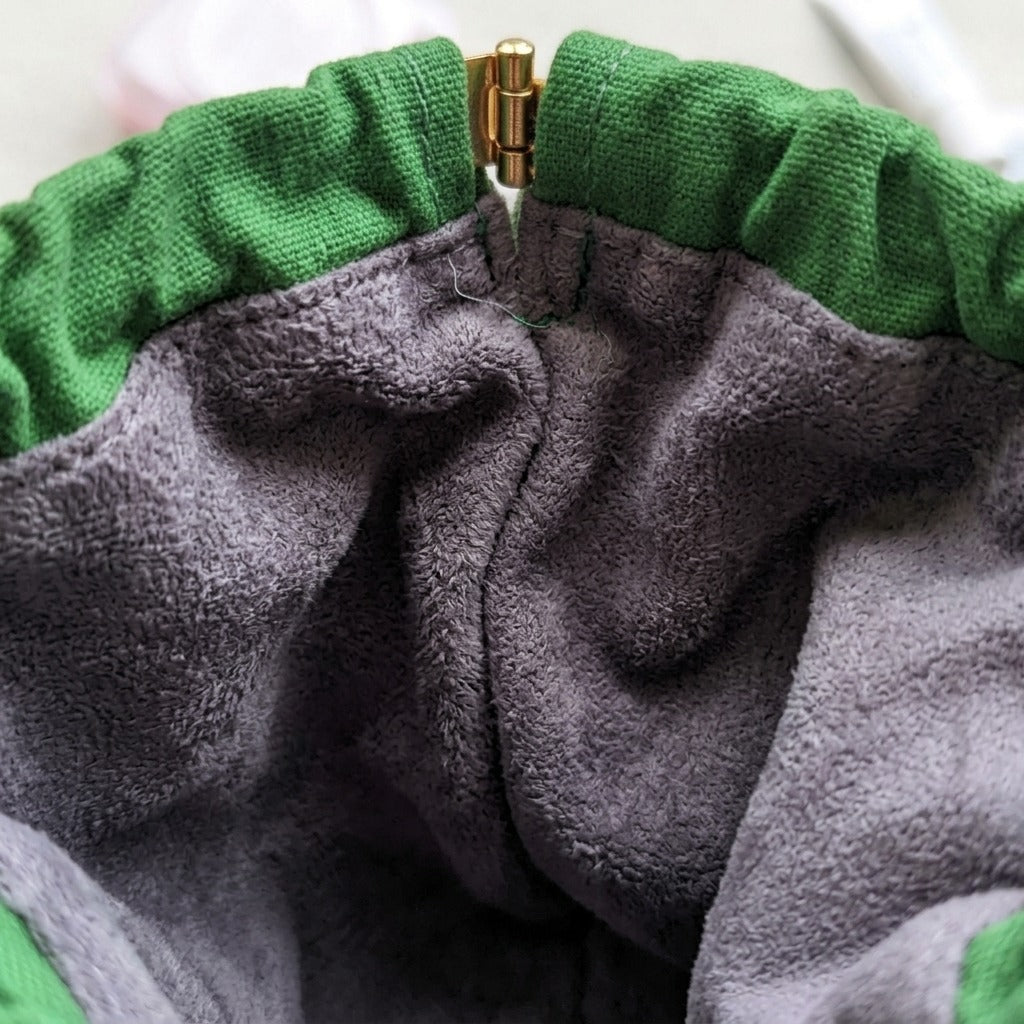 Duck Pond Travel Pouch squeeze-frame opening, showing scratch-proof interior lining, MonBebe Singapore