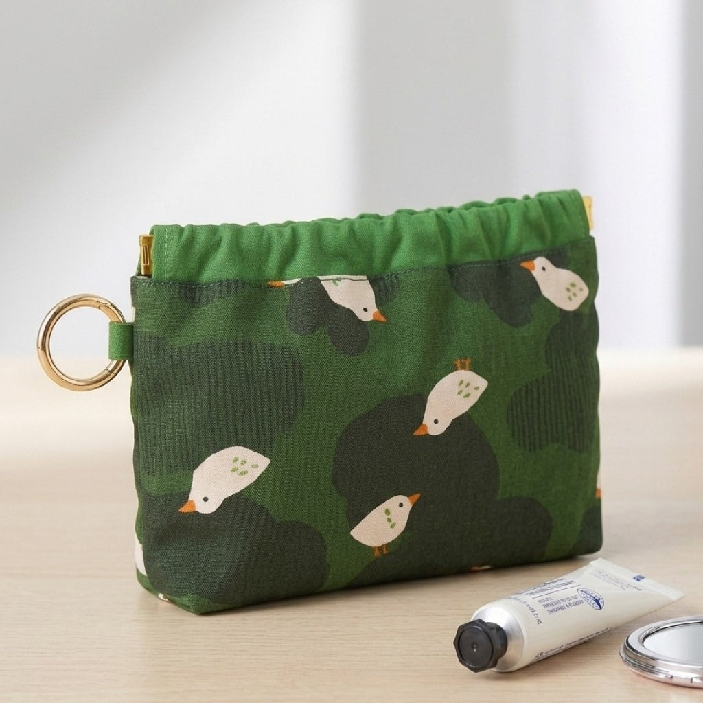 Duck Pond Travel Pouch styled with a phone charger, cable, power bank and earphones, MonBebe Singapore