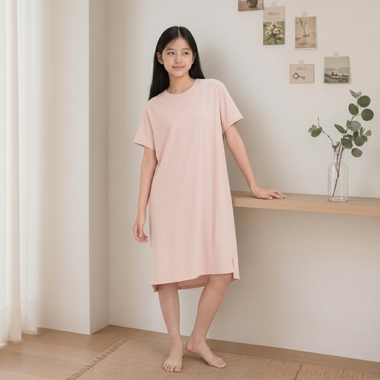 Girl wearing powder pink cool-touch lounge dress with built-in bra pad — ages 9 to 15
