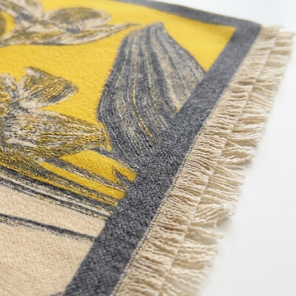 Close-up of Kii premium wool wrap shawl showing warm yellow and fabric texture detail —  MonBebe Singapore