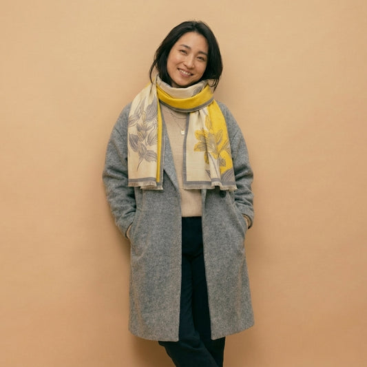 premium wool wrap shawl with warm yellow, styled on model in studio showing drape and fit