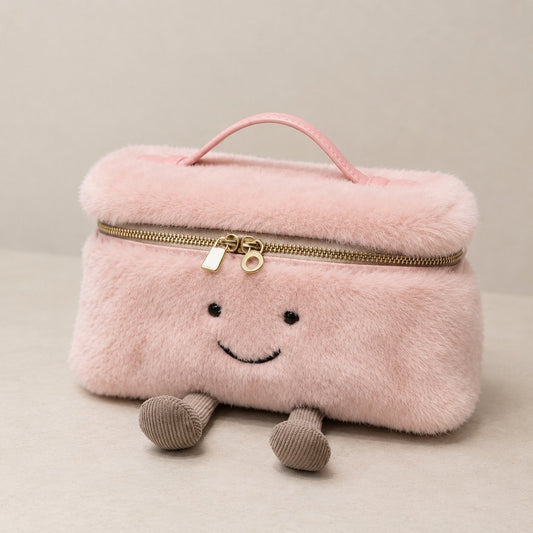 Pink furry Laura Smiley crossbody bag with gold zipper, pink leather handle, and corduroy feet