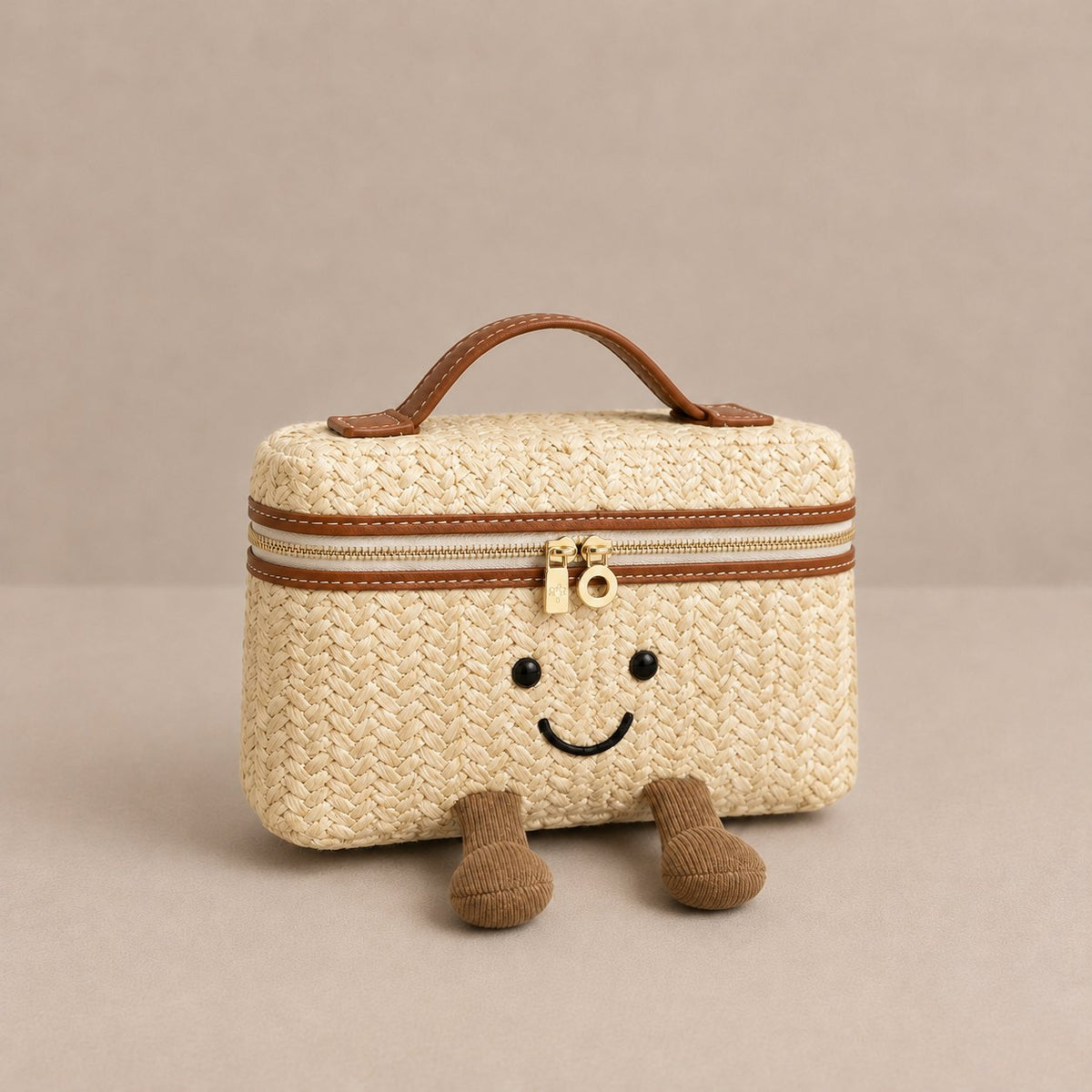 Laura Smiley crossbody bag in straw material with gold zipper, tan leather handle, and corduroy feet