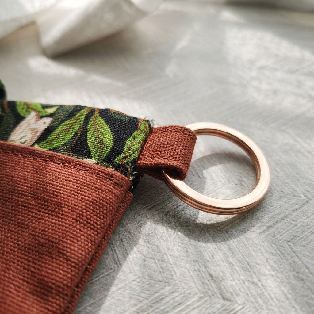 Close-up of the gold keyring loop on the Linnet book pouch, MonBebe Singapore
