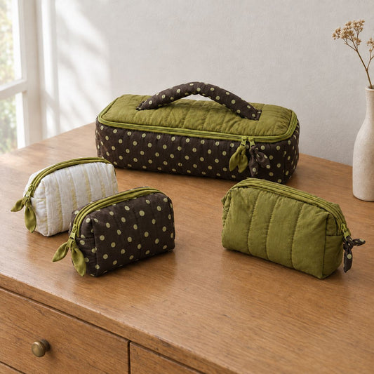 Poppy quilted travel case in polka dot, olive and pale olive stripe styled on a wooden dresser, MonBebe Singapore