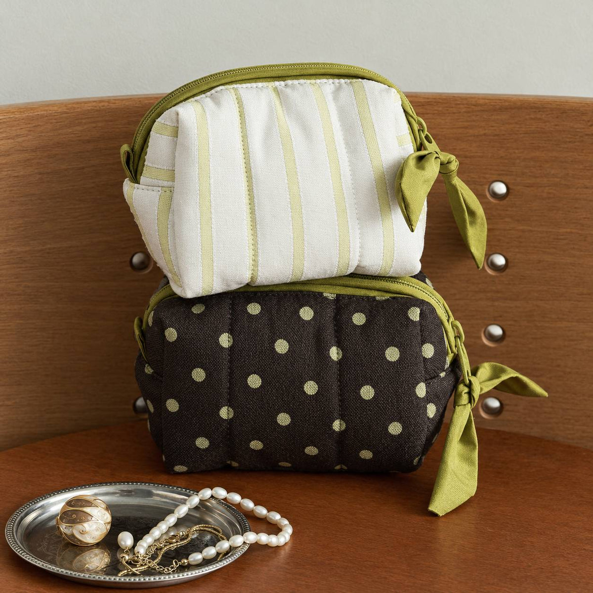 Poppy quilted travel case Small pouches in pale olive stripe and polka dot stacked beside a jewelry tray, MonBebe Singapore
