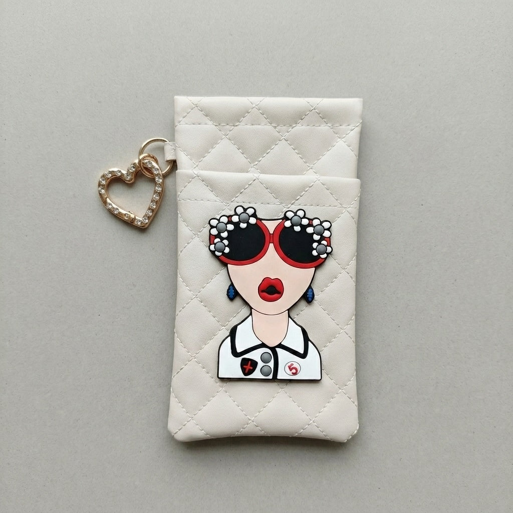 Cream quilted glasses case with illustrated face patch and heart-shaped rhinestone hook