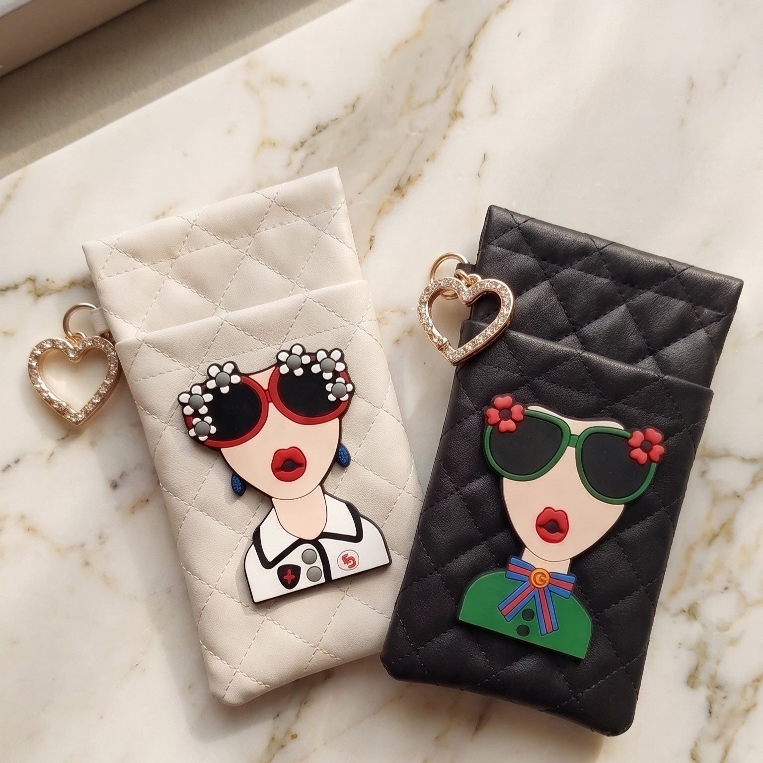 Cream and black glasses case with illustrated face patch styled with sunglasses and perfume, MonBebe Singapore