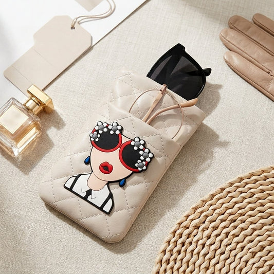 Cream glasses case with illustrated face patch styled with sunglasses and perfume, MonBebe Singapore
