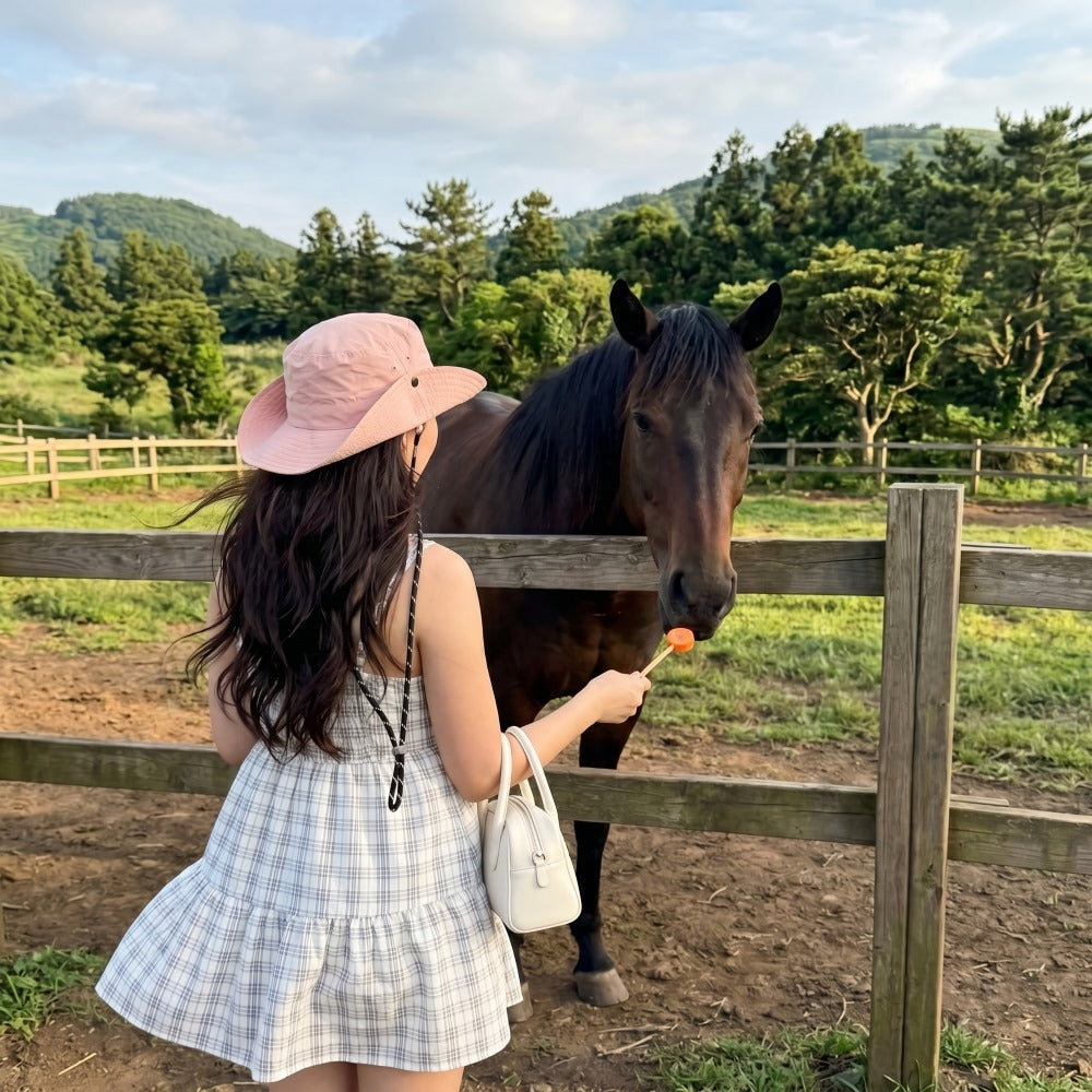 Woman wearing packable UPF50+ wide brim sun hat outdoors, MonBebe Singapore