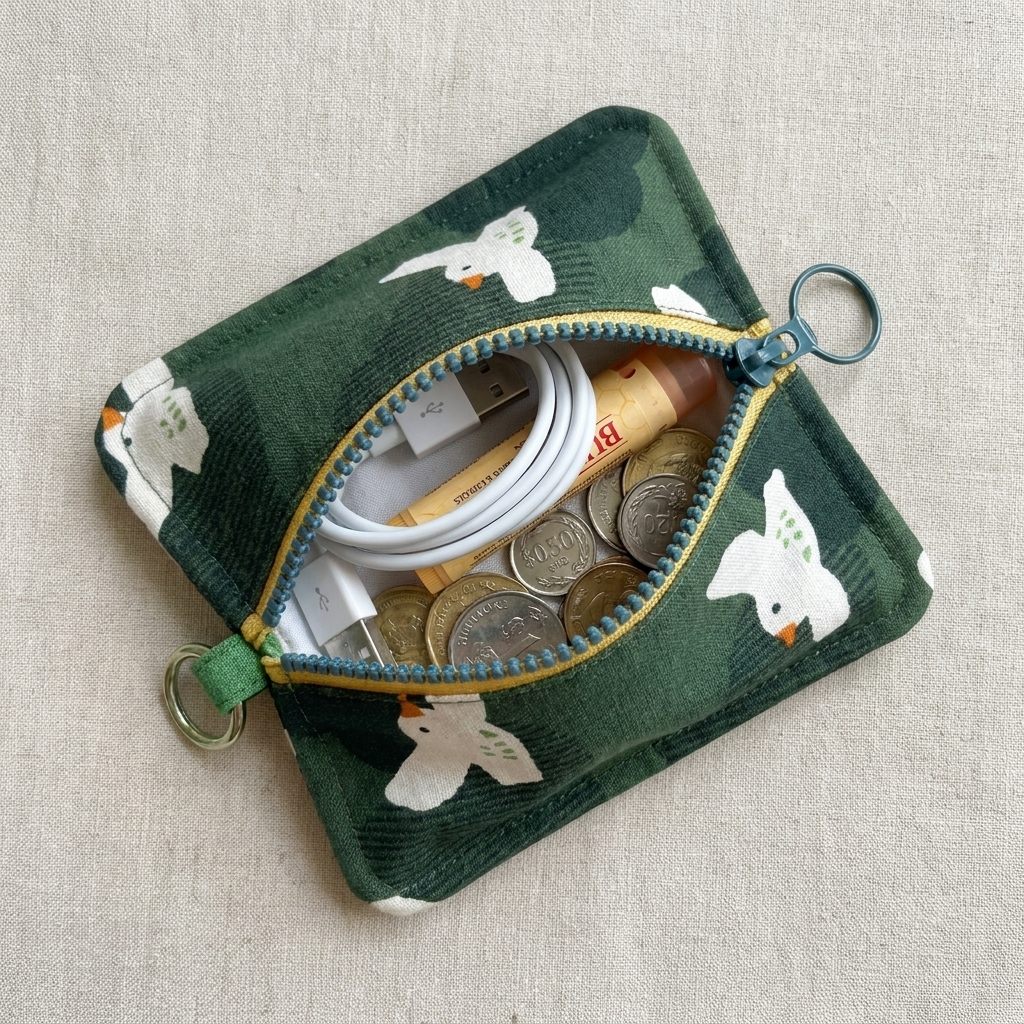 Peppermint Bird Everyday Pouch styled with a cable, earphones, lip balm and keys, MonBebe Singapore