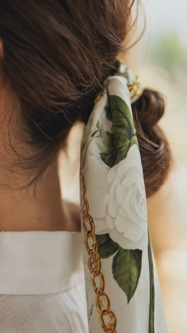Video of Camellia mulberry silk scarf showing ivory floral gold chain print and fabric texture detail