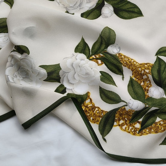 Video of Camellia mulberry silk scarf showing ivory floral gold chain print and fabric texture detail —  MonBebe Singapore
