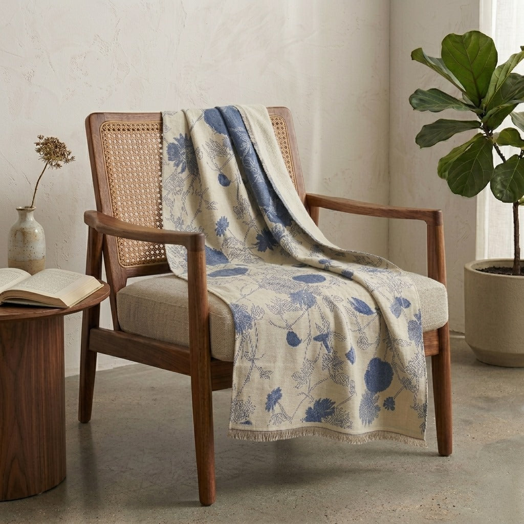 Sora premium wool shawl with ivory blue botanical detail draped over chair, styled as a home accessory