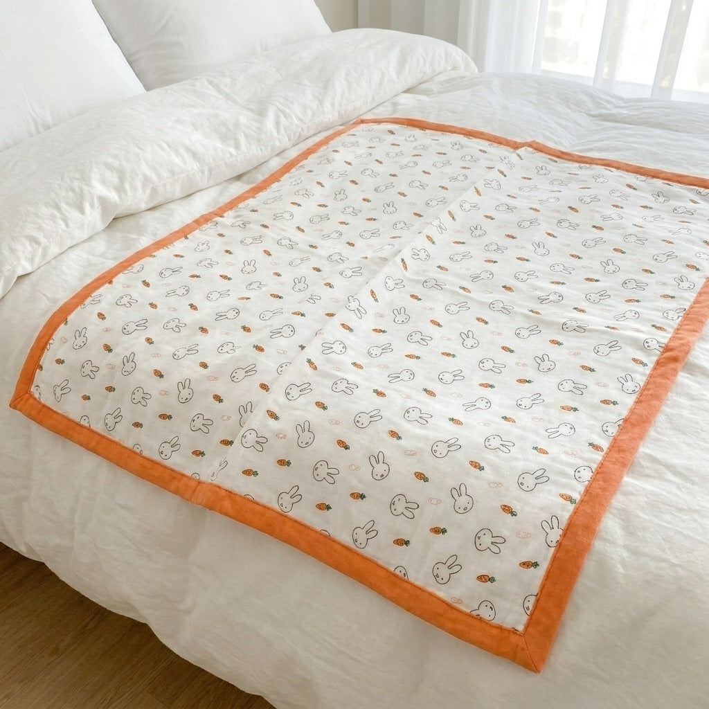 Tokki bamboo cotton blanket in bunny and carrot print, lifestyle bed shot, MonBebe
