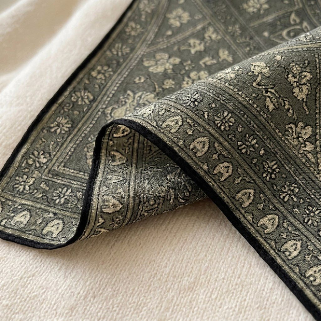 Close-up of Veil triangular silk-wool scarf showing paisley print and fabric texture detail —  MonBebe Singapore